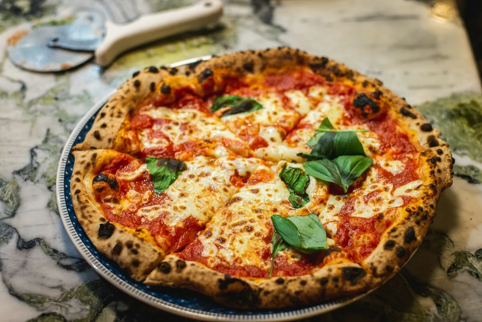 A margherita pizza with basil seen from above