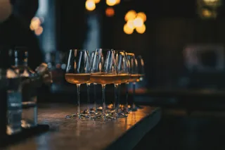 A row of wine glasses on the bar