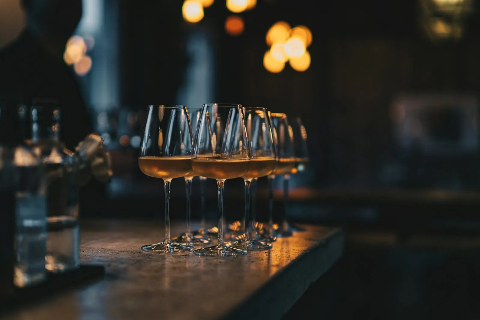 A row of wine glasses on the bar
