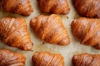 Golden croissants on baking paper