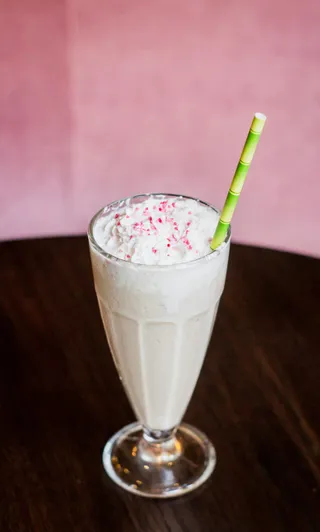 A strawberry milkshake in a tall glass