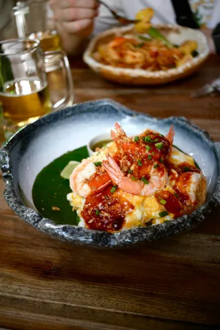 Shrimp and grits in a blue bowl