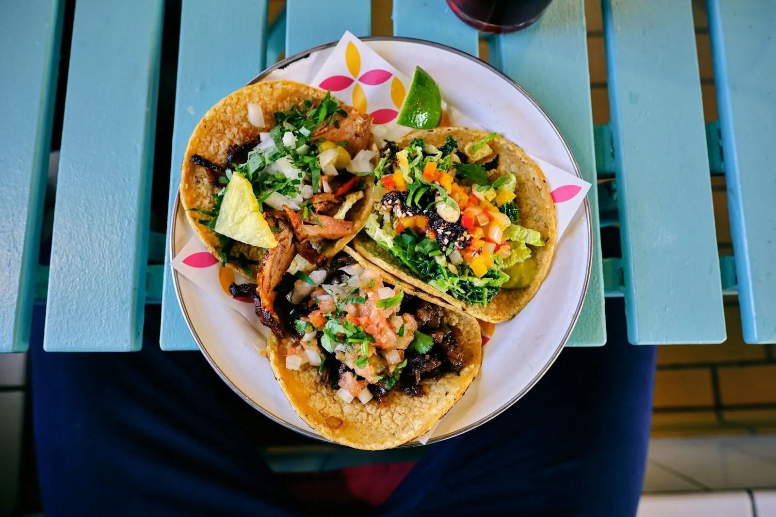 Fish tacos on a plate on a turquoise table