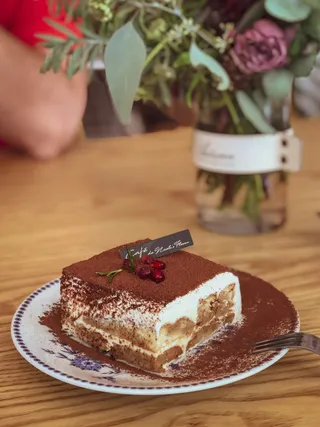 A square of tiramisu dusted with cocoa